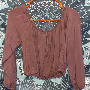 Mauve color blouse with tie in front .